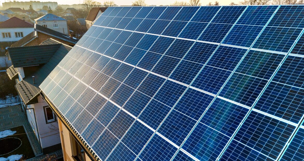 aerial-view-new-modern-two-story-house-cottage-with-blue-shiny-solar-photo-voltaic-panels-system-roof-renewable-ecological-green-energy-production-concept aerial-view-new-modern-two-story-house-cottage-with-blue-shiny-solar-photo-voltaic-panels-system-roof-renewable-ecological-green-energy-production-concept